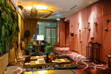 Cozy restaurant in a classic style. Interior with lit floor lamps
