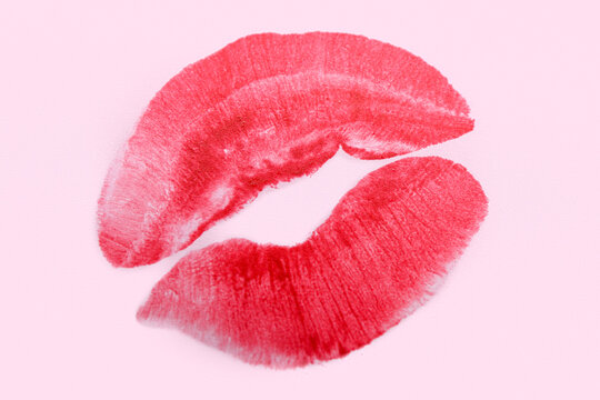 Red lipstick kiss mark on lilac background