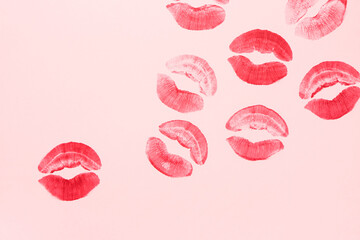 Red lipstick kiss marks on pink background