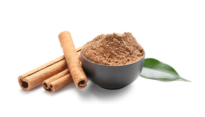 Bowl of powder with cinnamon sticks and leaf on white background