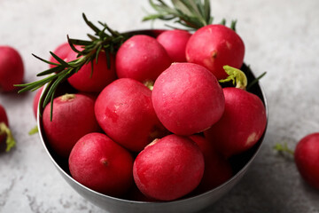Bowl with fresh radish on light background, closeup