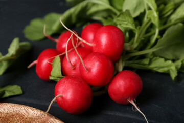 Bunch of ripe radish on dark background, closeup