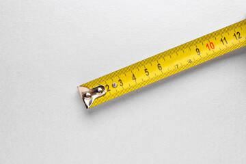 Measuring tape on grey background