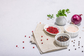 Obraz na płótnie Canvas Kitchen cooking background with assorted peppercorn, purple onion, fresh parsley and sea salt