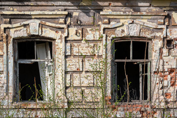empty windows of a damaged house in Ukraine