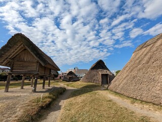 Fototapeta na wymiar 日本の静岡県静岡市の登呂遺跡で撮影した、弥生時代の住居跡と倉庫跡の風景