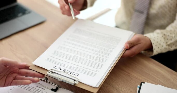 Seo passes the contract to client in office for signing. Mortgage lease or employment document