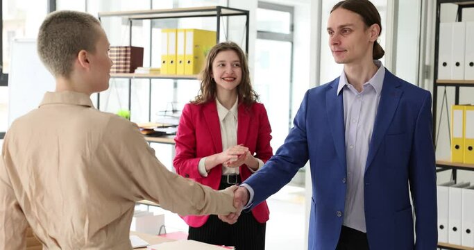 Employees partners shake hands at meeting. Partners get to know each other greet or congratulate colleague on promotion