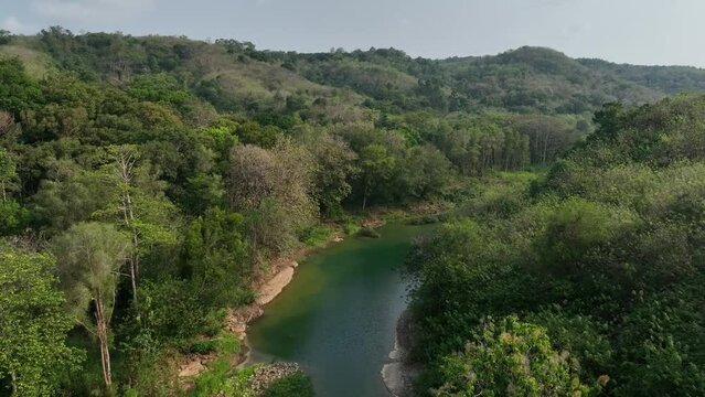 Slow climb beyond the Gantung Wanagama Bridge over the Oyo river. Tropical forest on an overcast day at the start of the wet season. Conditions: Smoke and haze present.