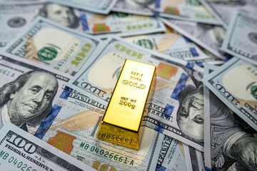 100 dollar bill with gold bars as finance background
