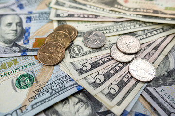 background of ste different us dollar paper money and coin cent