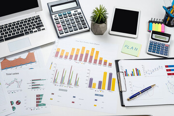 business graph documents and calculator, supplies on office desk table