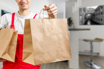 paper containers for takeaway food. Delivery man is carrying