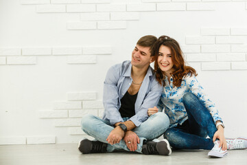 Fototapeta na wymiar Portrait of young couple smiling on white background.