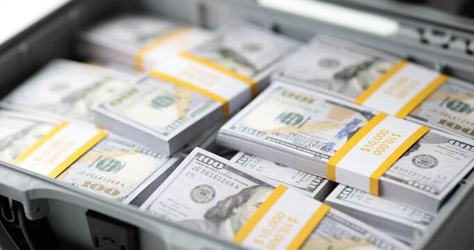 Open suitcase with stacks of one million dollar bills. Profitable financial investments and wealth