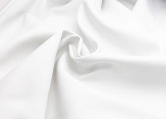 Texture for a background with crumpled and wrinkled white satin cloth, fabric and materials. There is an empty blank space to use as a copy space. the surface and the shadow.