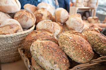 Rye sourdough bread with sunflower seeds on the counter. Bulging round loaves of wholegrain bread from a private bakery. Small business