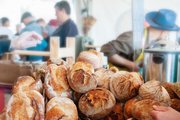 Rye sourdough bread with sunflower seeds on the counter. Bulging round loaves of wholegrain bread from a private bakery. Small business