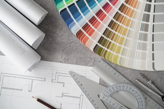 Home floor plans or building blueprint projects and open color palette guide catalog with colour swatches. Architect or interior design concept. Choosing paint colors for house, flat or apartment.