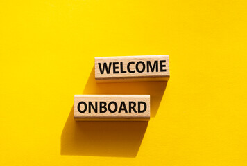 Welcome onboard symbol. Concept words Welcome onboard on wooden blocks. Beautiful yellow background. Business and Welcome onboard concept. Copy space.