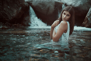 Young woman alone in mountain stream