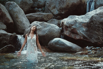 Young woman inspired in mountain stream - 593869292