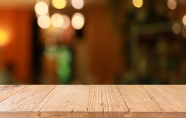 Empty wooden table in front of abstract blurred background of coffee shop . can be used for display or montage your products.Mock up for display of product