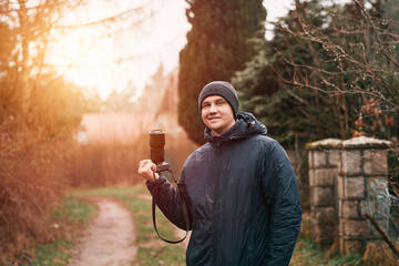 Man photographer with modern mirrorless camera outdoor. Photographer website banner concept.