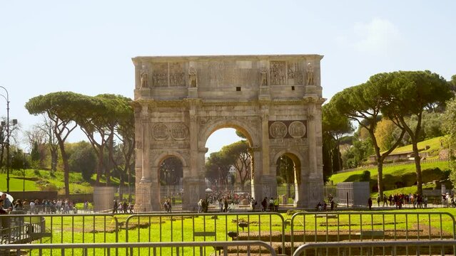 Panoramic shot of the triumphal arch in Rome, Italy. Tourists walking nearby.