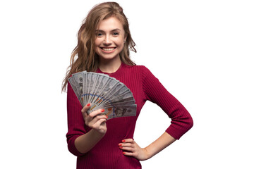 Portrait of a happy satisfied girl holding bunch of money banknotes and looking at camera isolated...