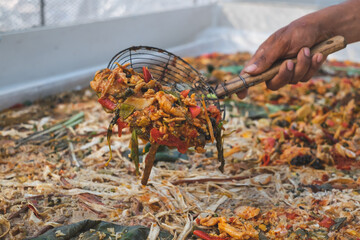 Hand holding Colorful food waste. Concept of biodegradable, decomposition or bio waste. Sustainable and eco-friendly idea. Alternative way to reduce or recycle waste. Food management responsible.