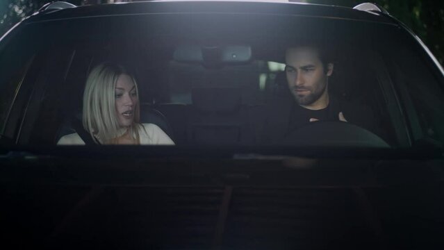 A young couple is in a hurry and got into the car. The driver lost his car key. Two people are very anxious and late for work. The girl helps to find the car's keys.