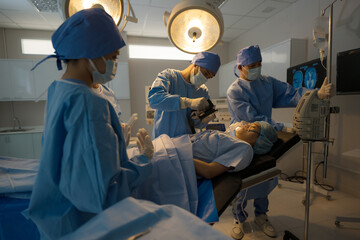 Doctor, nurse doing surgery on patient.