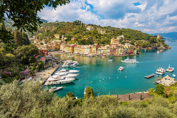 Fototapeta na wymiar Panoramic view of the famous village of Portofino, luxury tourist resort in Genoa Province, Liguria, Italy, Europe. Port and colorful houses, Mediterranean sea (Ligurian sea).
