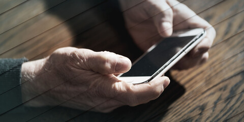 Hands using a phone, hard light effect, geometric pattern