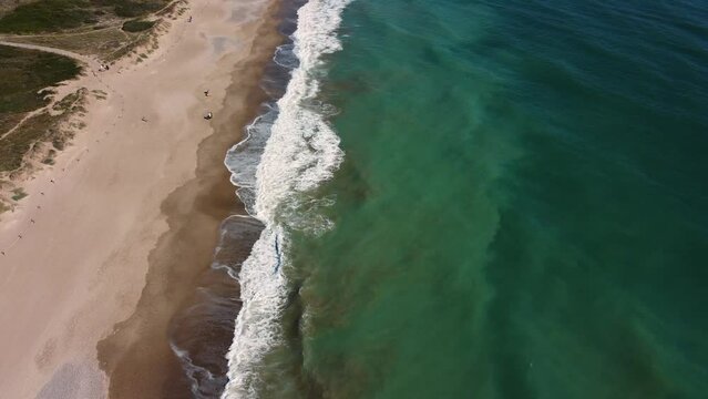 Aerial view of thr beach along the coastline. The drone flies forward. Spain