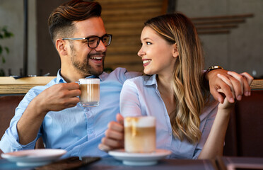 Romantic loving couple drinking coffee, having a date in the cafe.