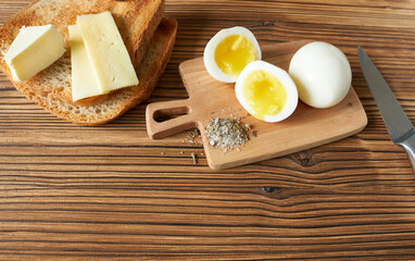 Fried toast with butter and cheese and boiled eggs. Making a sandwich. Morning meal.