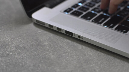 Hand typing on laptop keyboard, personal computer use for work at office or home
