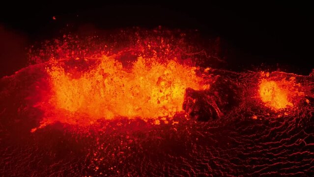 Aerial video of lava erupting and flowing from a mountain, Iceland