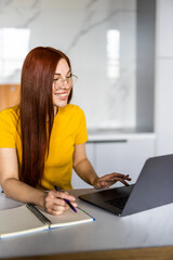 Joyful girl smiling and talking via video call on laptop, home office, working remotely, explaining a strategy, freelancer, discussing a new project with team. High quality photo