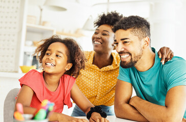 child family woman home happy man father mother lifestyle happiness daughter  together parent love bonding cheerful fun table