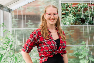 Portrait woman working inside greenhouse garden - Nursery and spring concept