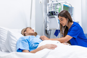 Obraz premium Young woman laying on bed at hospital ward. medicine, health care and quarantine concept. female patient lying in bed in hospital ward