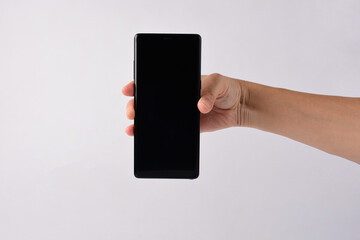 Hand and smartphone with blank white screen and black stylus for writing isolated on white...