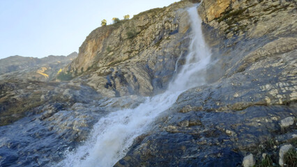 Naklejka na ściany i meble pretty mountain ridge highland fast waterfall at summer day - photo of nature