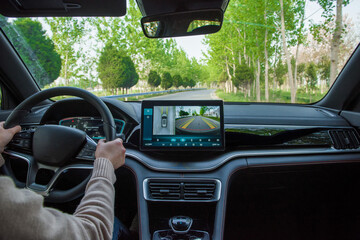 hangd holding steering wheel driving a car.interior of a modern car
