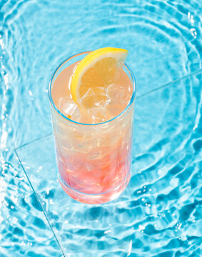 cocktail and lemon near the pool