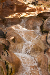 A small waterfall and rocks in the tropical jungle. A cozy place to travel. A place for meditation