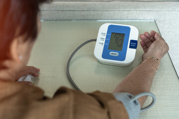Blood pressure monitoring with digital sphygmomanometer for elder patient with hypertension or high...